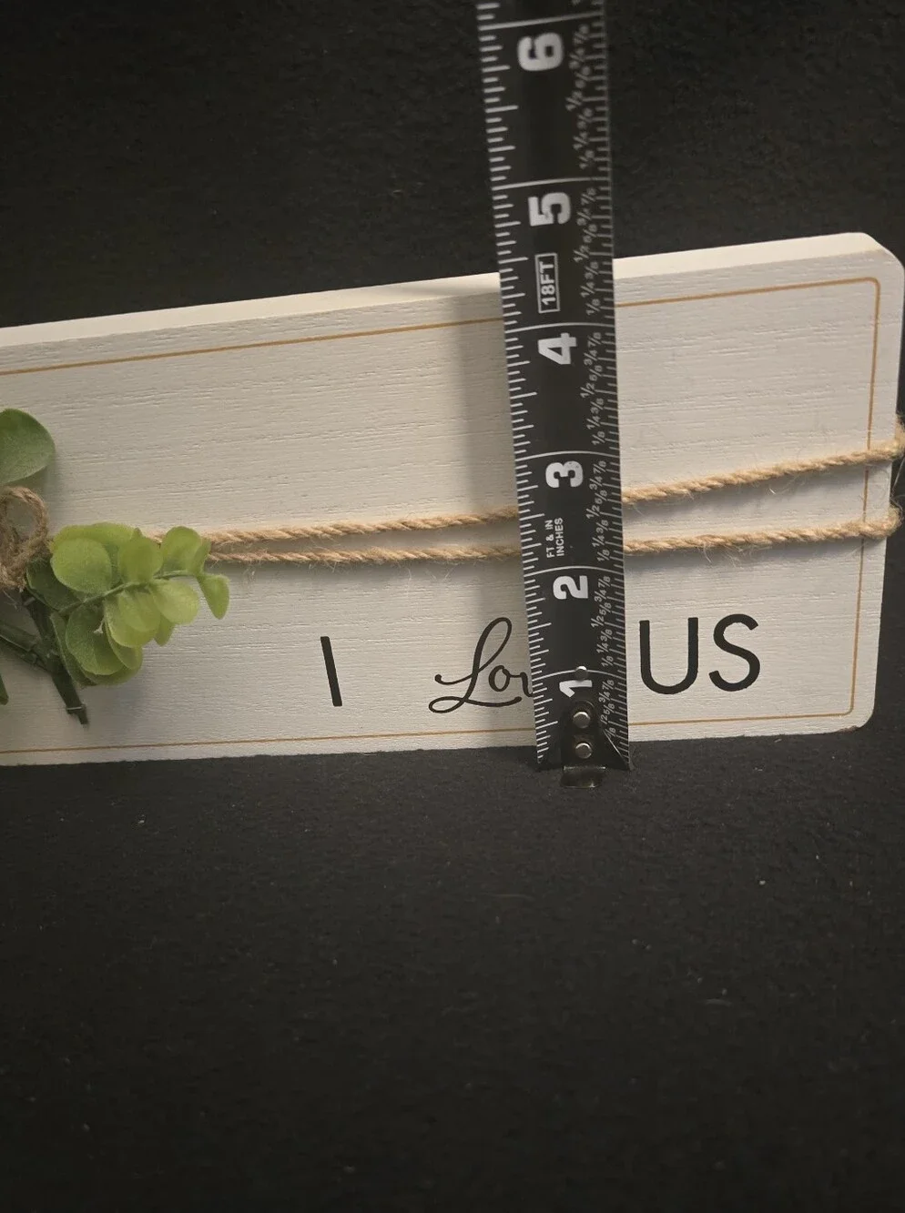 White 'I Love Us'  Sign with Green Faux Foliage